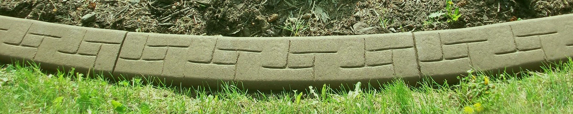 Close up of a pattern stamped continuous concrete border installed by Unique Curbing